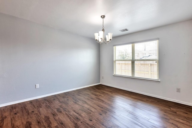16531 Silla Ridge Ct, Houston, TX 77049 - empty room featuring a chandelier, dark wood-style floors, and baseboards
