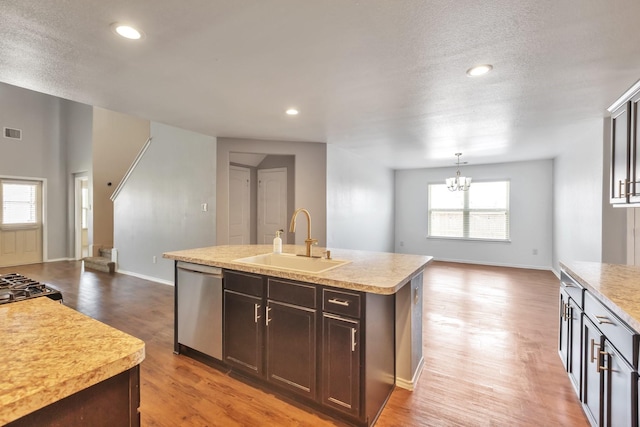16531 Silla Ridge Ct, Houston, TX 77049 - kitchen featuring a sink, stainless steel dishwasher, light countertops, an island with sink, and light wood-style flooring