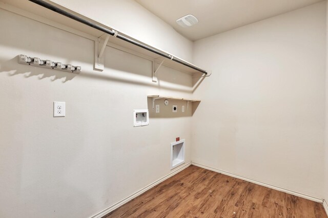 16531 Silla Ridge Ct, Houston, TX 77049 - laundry area with electric dryer hookup, gas dryer hookup, hookup for a washing machine, light wood finished floors, and baseboards