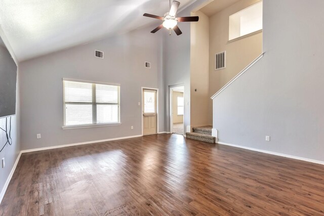 16531 Silla Ridge Ct, Houston, TX 77049 - unfurnished living room with ceiling fan, dark wood-style floors, baseboards, stairs, and high vaulted ceiling