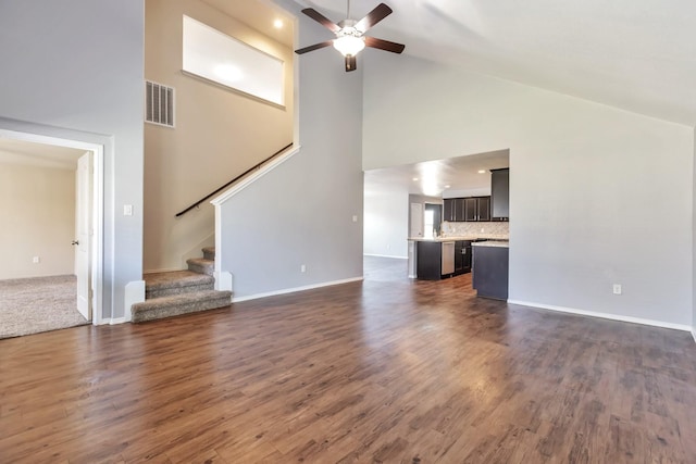 16531 Silla Ridge Ct, Houston, TX 77049 - unfurnished living room with high vaulted ceiling, a ceiling fan, stairs, dark wood-type flooring, and baseboards