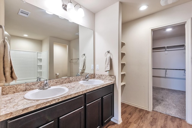 16531 Silla Ridge Ct, Houston, TX 77049 - full bath featuring double vanity, a spacious closet, wood finished floors, and recessed lighting