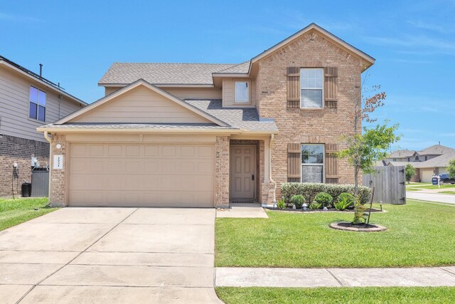 16531 Silla Ridge Ct, Houston, TX 77049 - traditional-style home with brick siding, a front yard, driveway, a shingled roof, and a garage