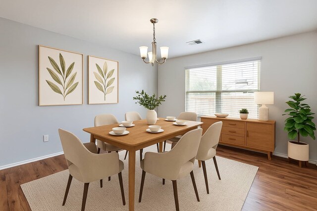 16531 Silla Ridge Ct, Houston, TX 77049 - dining area with baseboards, a chandelier, and wood finished floors