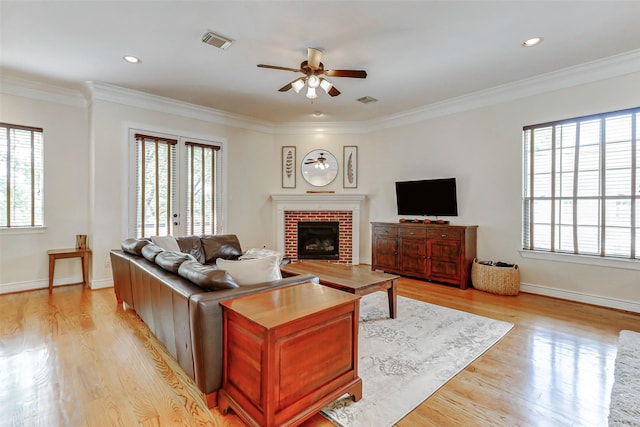 1529 Rosewood St, Houston, TX 77004 - living area with a ceiling fan, light wood-type flooring, a fireplace, crown molding, and baseboards
