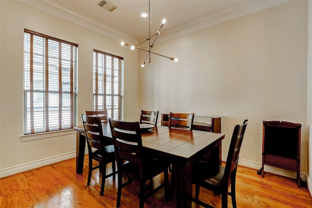 1529 Rosewood St, Houston, TX 77004 - dining space with a chandelier, crown molding, healthy amount of natural light, and light wood-style flooring