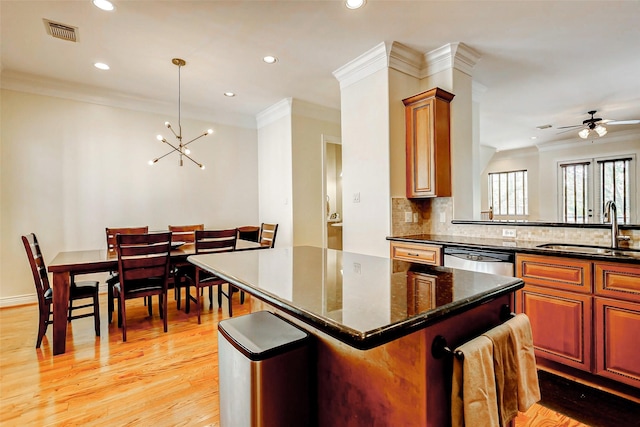 1529 Rosewood St, Houston, TX 77004 - kitchen with a sink, recessed lighting, ornamental molding, a kitchen island, and decorative backsplash