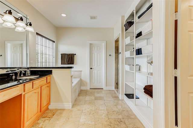 1529 Rosewood St, Houston, TX 77004 - full bath featuring vanity, a shower stall, a bath, and baseboards