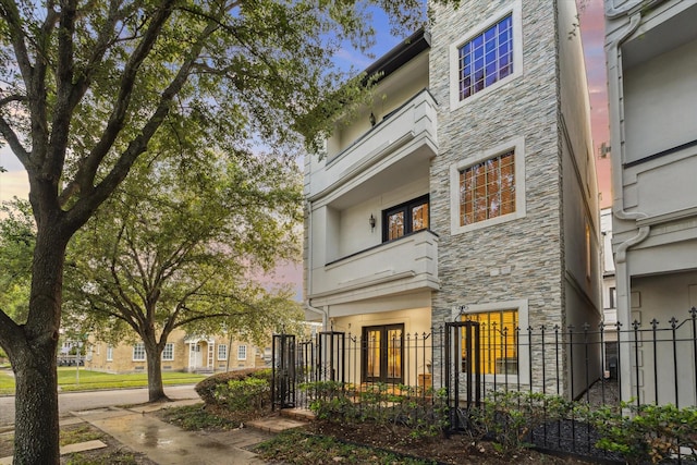 1529 Rosewood St, Houston, TX 77004 - view of front facade featuring stone siding and french doors