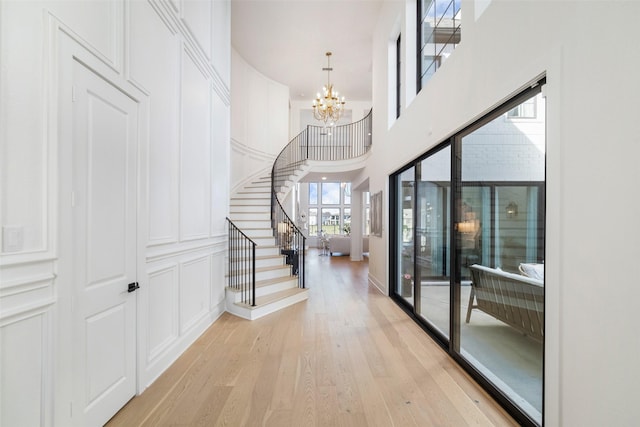 11303 Flying Admiral Dr, Cypress, TX 77433 - entryway with a chandelier, light wood-style floors, stairs, and a towering ceiling