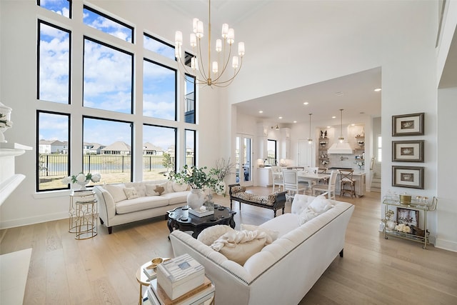 11303 Flying Admiral Dr, Cypress, TX 77433 - living area featuring a towering ceiling, light wood-type flooring, baseboards, and a chandelier