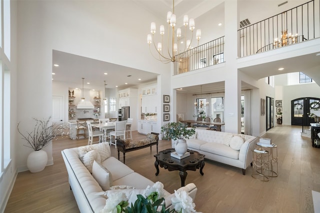 11303 Flying Admiral Dr, Cypress, TX 77433 - living area with a high ceiling, light wood-type flooring, a chandelier, and recessed lighting