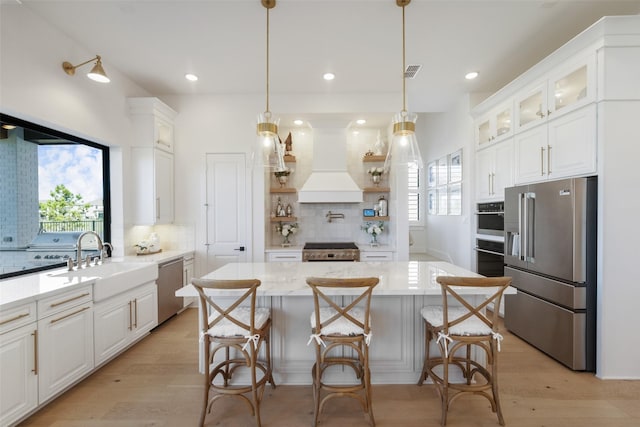 11303 Flying Admiral Dr, Cypress, TX 77433 - kitchen with appliances with stainless steel finishes, custom range hood, backsplash, white cabinetry, and a sink