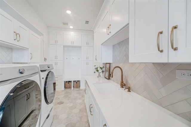 11303 Flying Admiral Dr, Cypress, TX 77433 - washroom with washing machine and clothes dryer, cabinet space, recessed lighting, and light tile patterned flooring