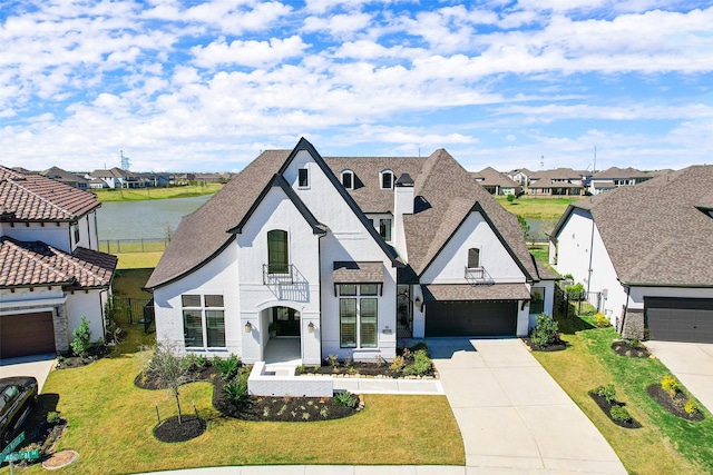11303 Flying Admiral Dr, Cypress, TX 77433 - french country home with concrete driveway, a residential view, a front lawn, and roof with shingles