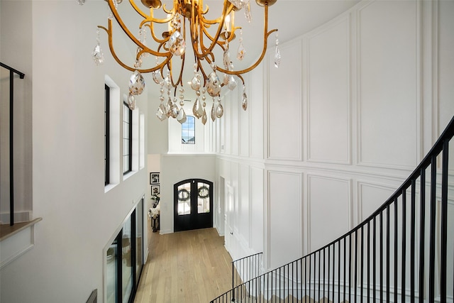 11303 Flying Admiral Dr, Cypress, TX 77433 - foyer with a chandelier, a high ceiling, light wood-type flooring, and stairs