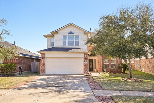 14 Carmel Chase Ct, Manvel, TX 77578 - traditional-style house featuring an attached garage, concrete driveway, and brick siding