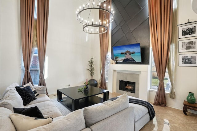 14 Carmel Chase Ct, Manvel, TX 77578 - living area with baseboards, a chandelier, healthy amount of natural light, light tile patterned flooring, and a high ceiling