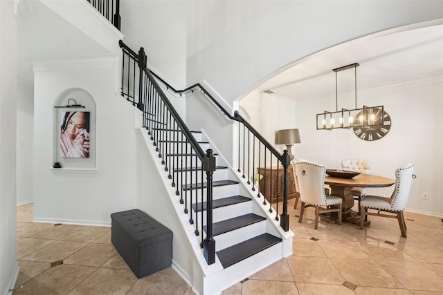 14 Carmel Chase Ct, Manvel, TX 77578 - staircase with a chandelier, tile patterned flooring, ornamental molding, arched walkways, and baseboards
