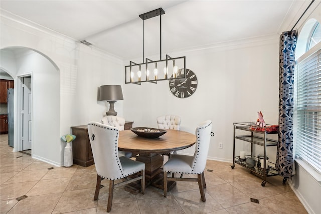 14 Carmel Chase Ct, Manvel, TX 77578 - dining space with a chandelier, ornamental molding, arched walkways, light tile patterned flooring, and baseboards