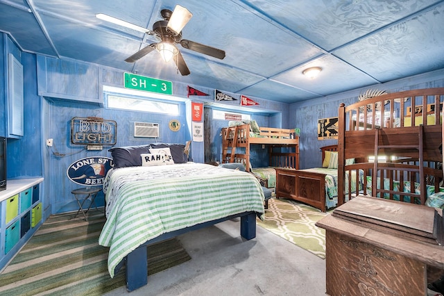 134 Private Road 652, Sargent, TX 77414 - bedroom with a wall mounted air conditioner, concrete floors, and wooden walls