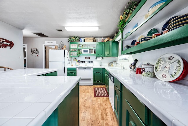 134 Private Road 652, Sargent, TX 77414 - kitchen featuring green cabinets, white appliances, open shelves, tile counters, and a textured ceiling