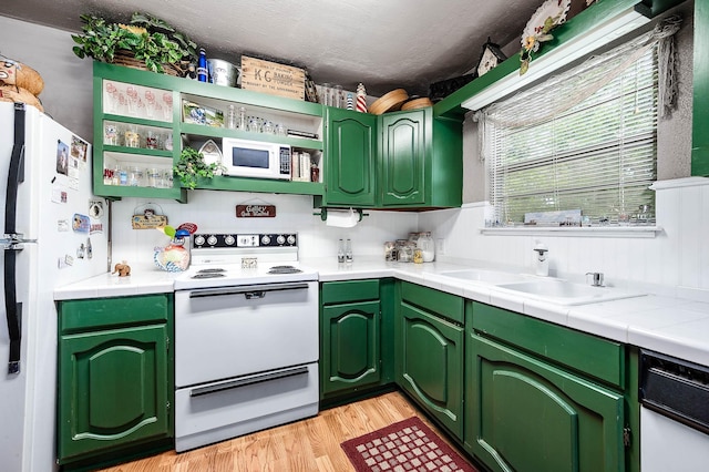 134 Private Road 652, Sargent, TX 77414 - kitchen featuring white appliances, light wood-style flooring, open shelves, a sink, and green cabinetry
