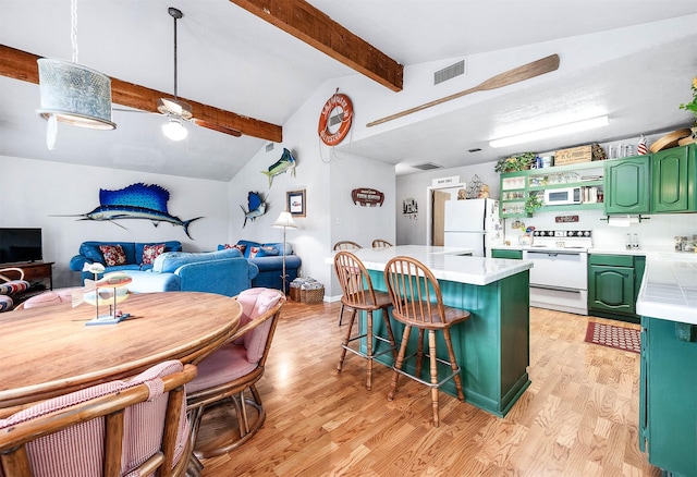 134 Private Road 652, Sargent, TX 77414 - kitchen featuring white appliances, green cabinetry, light countertops, light wood-style floors, and a breakfast bar area