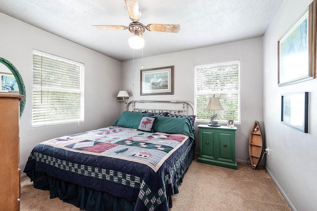 134 Private Road 652, Sargent, TX 77414 - bedroom featuring light colored carpet, a textured ceiling, baseboards, and a ceiling fan