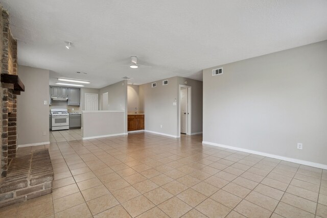 12115 Essenbruk Dr, Houston, TX 77066 - unfurnished living room with a ceiling fan, light tile patterned floors, and baseboards