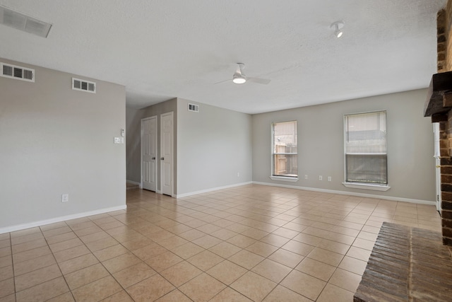 12115 Essenbruk Dr, Houston, TX 77066 - unfurnished living room with ceiling fan, light tile patterned flooring, a textured ceiling, and baseboards