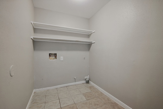 12115 Essenbruk Dr, Houston, TX 77066 - laundry area with washer hookup, light tile patterned floors, hookup for a gas dryer, and baseboards