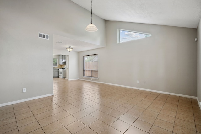 12115 Essenbruk Dr, Houston, TX 77066 - unfurnished living room featuring high vaulted ceiling, light tile patterned flooring, and baseboards