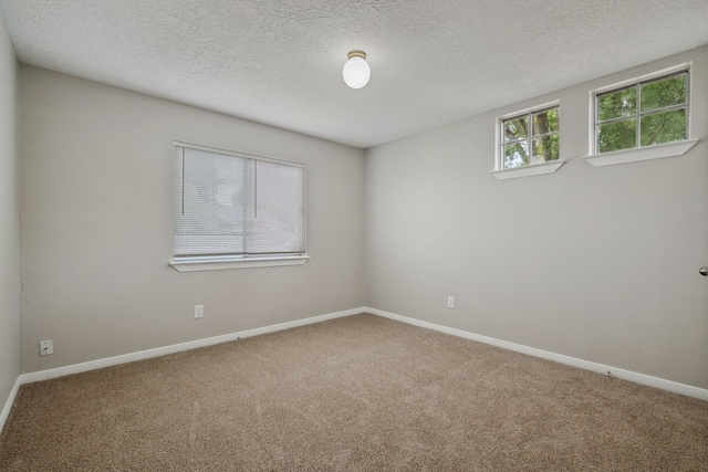 12115 Essenbruk Dr, Houston, TX 77066 - carpeted empty room with a textured ceiling and baseboards
