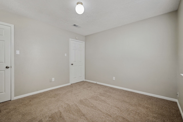 12115 Essenbruk Dr, Houston, TX 77066 - spare room with carpet, a textured ceiling, and baseboards