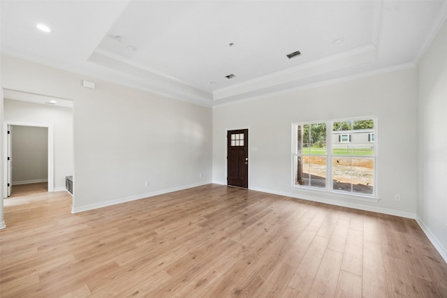 190 Faulkner Ave, Coldspring, TX 77331 - spare room featuring a raised ceiling, light wood-style floors, ornamental molding, and baseboards