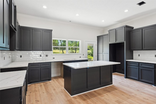 190 Faulkner Ave, Coldspring, TX 77331 - kitchen featuring light stone countertops, decorative backsplash, ornamental molding, light wood finished floors, and recessed lighting