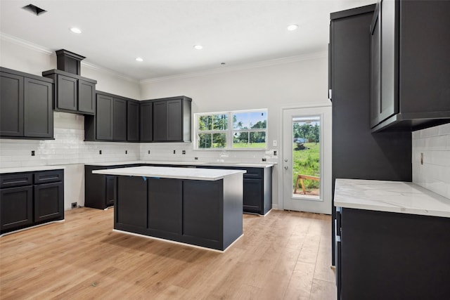 190 Faulkner Ave, Coldspring, TX 77331 - kitchen featuring backsplash, light wood finished floors, recessed lighting, light stone countertops, and crown molding