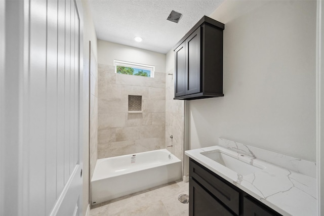 190 Faulkner Ave, Coldspring, TX 77331 - full bath featuring vanity, washtub / shower combination, a textured ceiling, and tile patterned floors