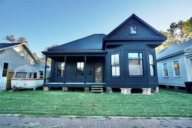 2215 Kane St, Houston, TX 77007 - view of front of property featuring a front lawn, a porch, metal roof, and a standing seam roof