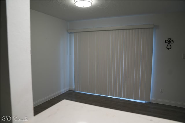 8803 Vinkins Rd, Houston, TX 77071 - unfurnished room featuring baseboards, wood finished floors, and a textured ceiling