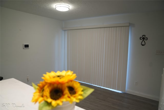 8803 Vinkins Rd, Houston, TX 77071 - detailed view of wood finished floors, baseboards, and a textured ceiling