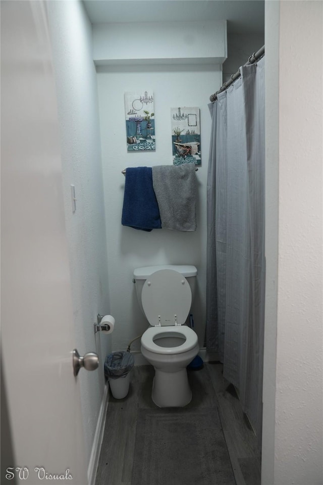 8803 Vinkins Rd, Houston, TX 77071 - bathroom with toilet, wood finished floors, baseboards, and a shower with curtain