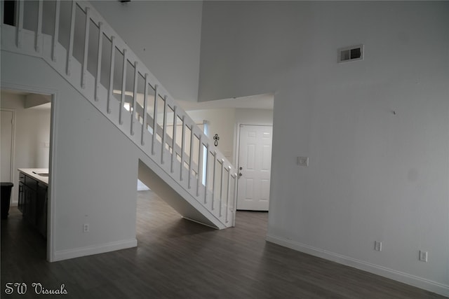 8803 Vinkins Rd, Houston, TX 77071 - stairs with wood finished floors, baseboards, and a high ceiling