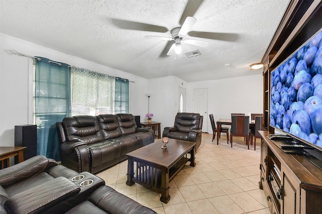 1607 Beusch Dr, Pasadena, TX 77502 - living area with a textured ceiling, ceiling fan, and light tile patterned floors