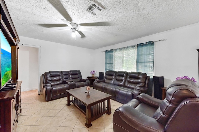 1607 Beusch Dr, Pasadena, TX 77502 - living room with a ceiling fan, light tile patterned floors, and a textured ceiling