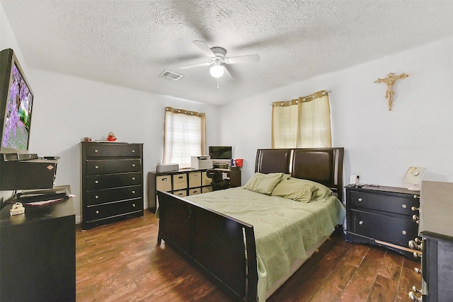 1607 Beusch Dr, Pasadena, TX 77502 - bedroom featuring dark wood finished floors, a textured ceiling, and ceiling fan