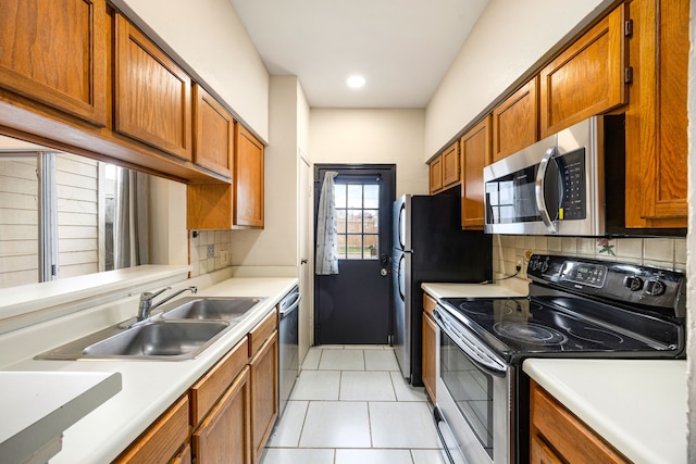 7575 Cambridge St Unit 1604, Houston, TX 77054 - kitchen featuring stainless steel appliances, a sink, tasteful backsplash, brown cabinets, and recessed lighting