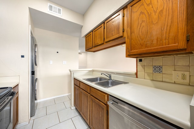 7575 Cambridge St Unit 1604, Houston, TX 77054 - kitchen with stainless steel dishwasher, a sink, brown cabinets, stove, and light countertops