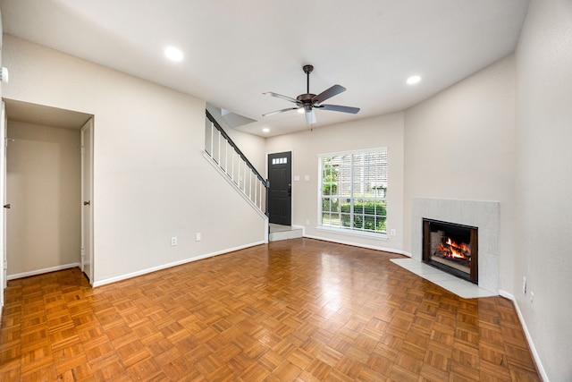 7575 Cambridge St Unit 1604, Houston, TX 77054 - unfurnished living room featuring baseboards, ceiling fan, a tiled fireplace, recessed lighting, and stairway